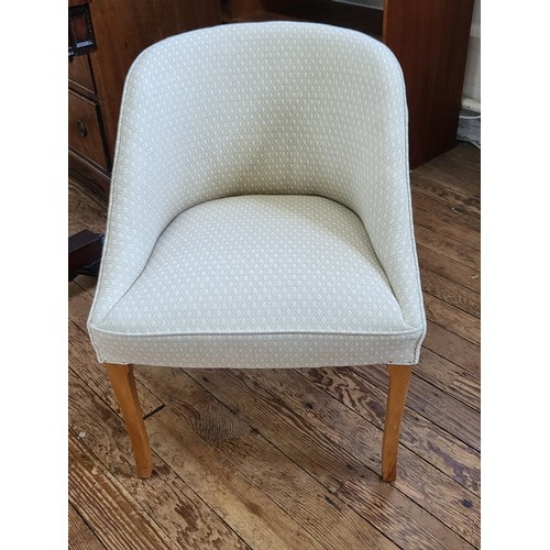 39 - A tub chair in cream upholstery 70cm x 53cm.