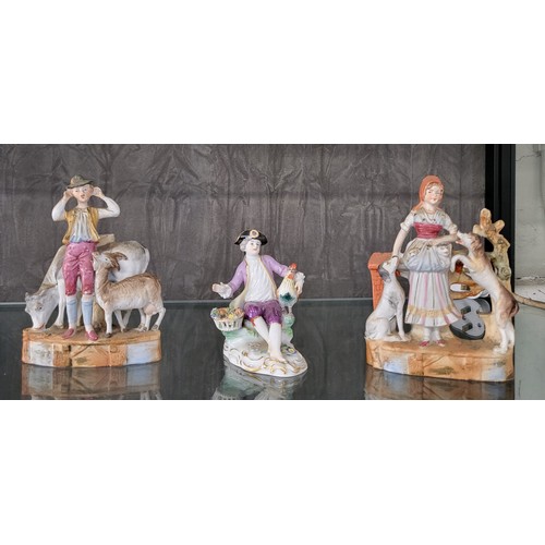 215 - A late Meissen figure seated with cockerel and basket of roses 11cm, and a pair of bisque figures of... 