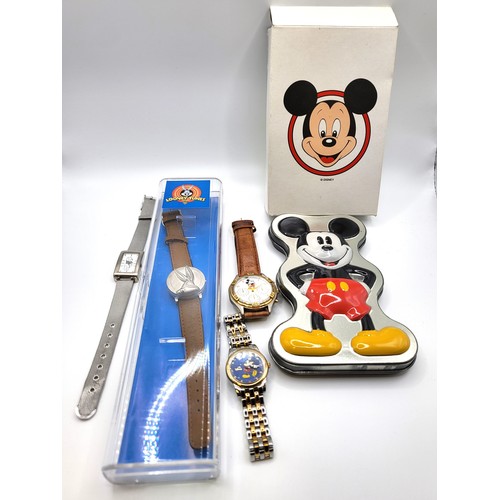 388 - Four novelty children's watches (two boxed) Mickey Mouse, Looney Tunes, Pooh Bear. (4)