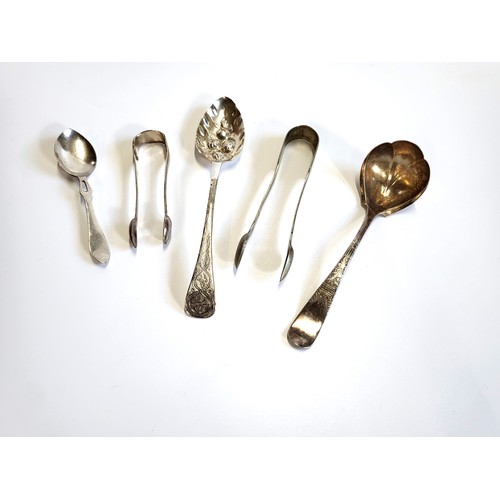 166 - A group of silver plate including two sugar tongs, a serving fruit spoon, a fluted and floral design... 