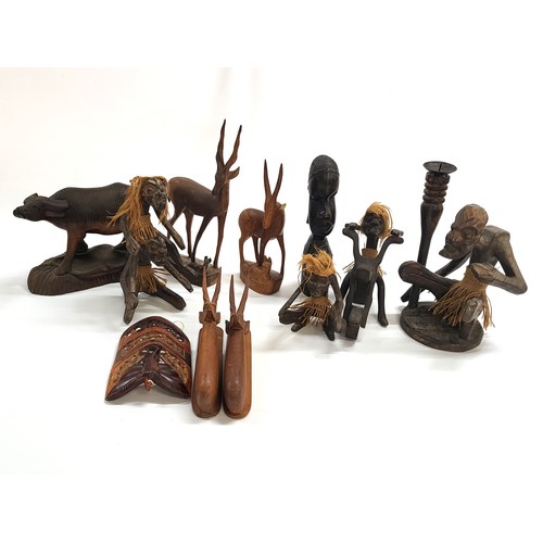 75 - A collection of wooden carved figures and animals, ranging in height from 14cm to 30cm. (11)