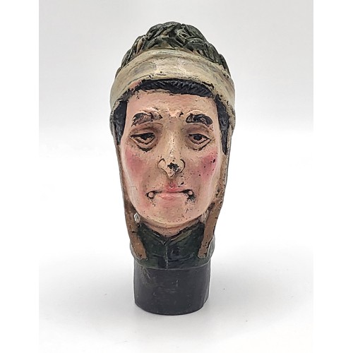 77 - A cold painted bronze walking cane handle in the form of a medieval serf's head. 146gms 8cm