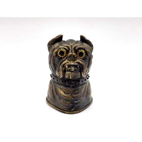 78 - A brass cased vesta in the form of a bulldog with glass eyes. 84gms 5cm.