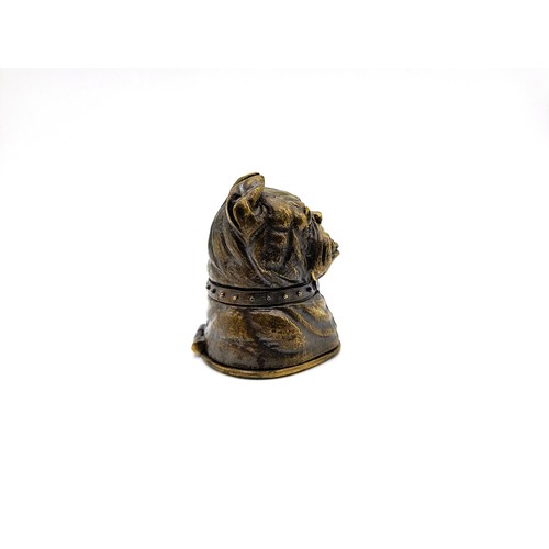 78 - A brass cased vesta in the form of a bulldog with glass eyes. 84gms 5cm.