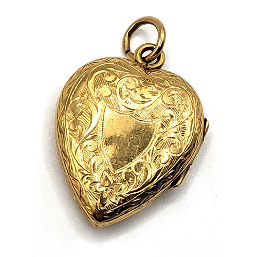 269 - A 20k yellow gold heart shaped locket with an ornate foliate and blank shield for monogram decoratio... 