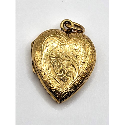 269 - A 20k yellow gold heart shaped locket with an ornate foliate and blank shield for monogram decoratio... 