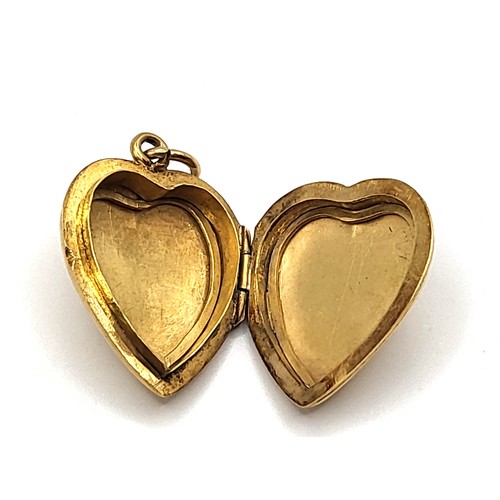 269 - A 20k yellow gold heart shaped locket with an ornate foliate and blank shield for monogram decoratio... 