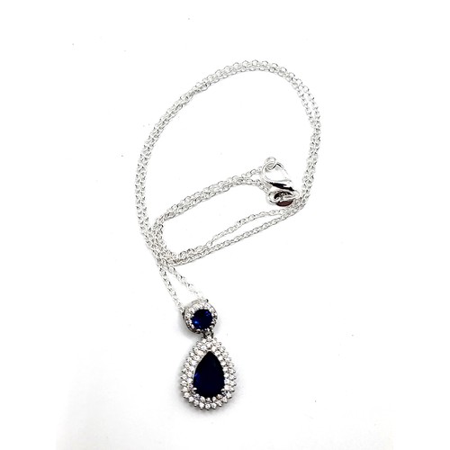 272 - A silver faux sapphire and cubic zirconia articulated pear shaped and round pendant on a silver colo... 