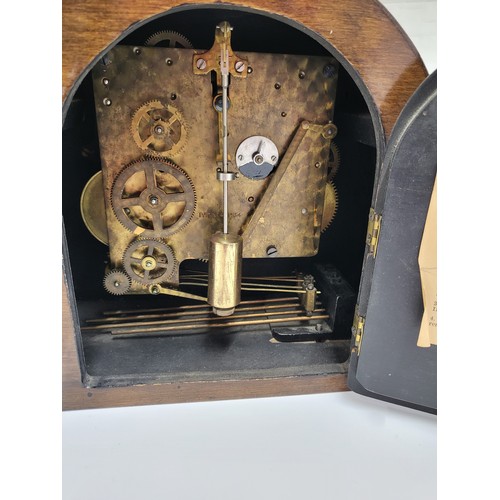 25 - A 1950's mantle clock with key. 34cm x 23cm