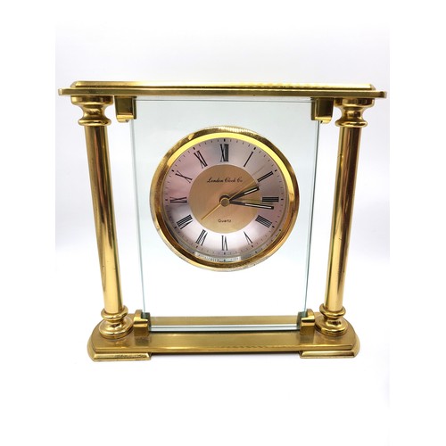 28 - A highly polished mahogany cased desk and photo combination clock together with a wooden brass finis... 