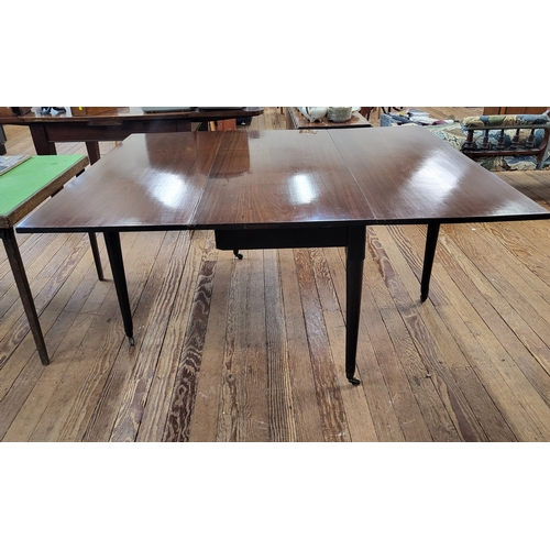 18 - An 18th century Cuban mahogany drop-leaf dining table on casters. Dimensions extended 72cm x 153cm x... 