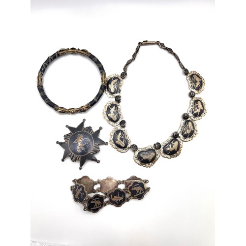 276A - A silver Thai style silver necklace and a matching bracelet, a Thai style brooch, and a bangle. 93gm... 