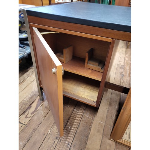 50 - A mid-century leather topped desk with drawers at the front and cupboards at the rear. 71cm x 169cm ... 