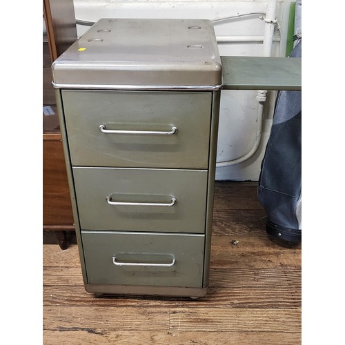 6 - A vintage sage green metal filing cabinet with three drawers and chrome handles, and a pull-out writ... 