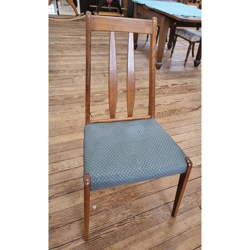 9 - A mid-century extending dining table 74cm x 152cm x 103cm and four upholstered slat back chairs (one... 