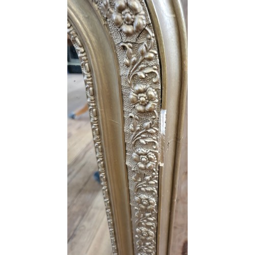 11 - Ornate gilt framed mirror 101cm x 56cm.