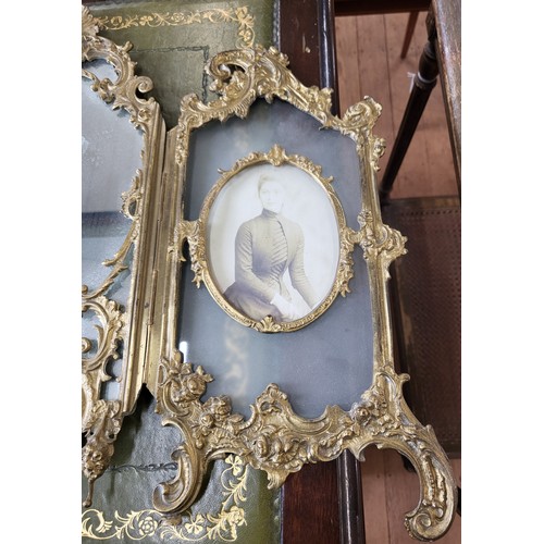 14 - Ornate brass dressing table mirror flanked by photo frames. 43cm x 62cm.