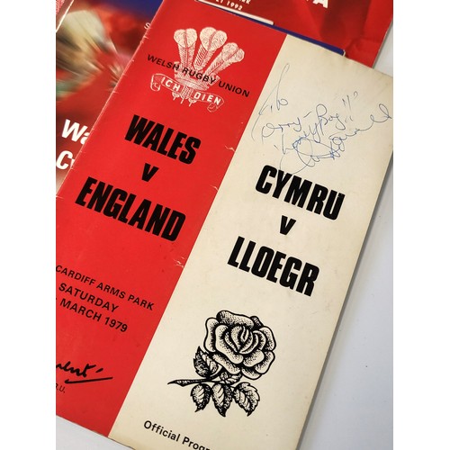 140 - A collection of rugby memorabilia, predominantly Welsh including programmes some signed, books and t... 