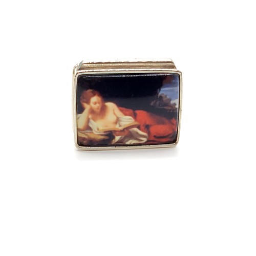 269 - A silver pill box with enamel lid depicting a reclining woman 3.5cm x 2.5cm 19.8gms.