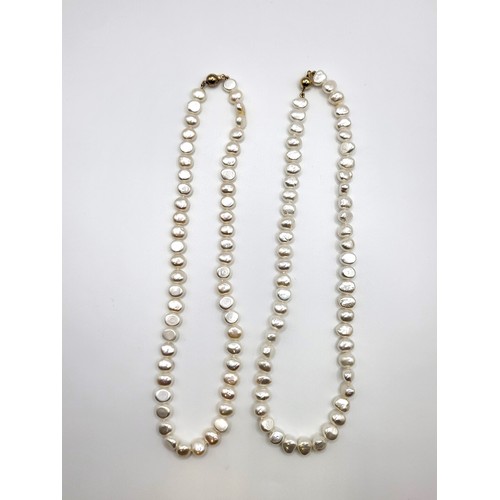 279 - A pair of choker length white cultured Baroque pearls (8-9mm) one with a 9ct yellow gold ball clasp,... 