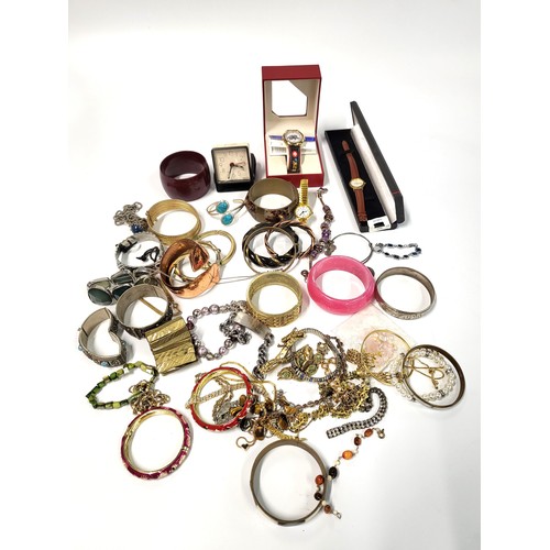 363 - A bag of costume jewellery including bracelets, bangles, and watches including a boxed Swatch and an... 