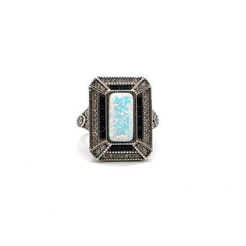 358 - A silver and cubic zirconia dress ring with man made opal panel. Size N 9.3gms.