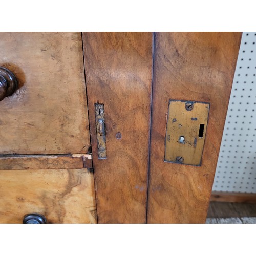 26 - A walnut Wellington chest with seven drawers with wooden knobs, right panel locks to secure drawers.... 