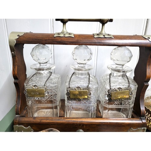 35 - A tantalus with three tags: Brandy, Gin, and Rum 33cm x 34cm, and a collection of silver plate inclu... 