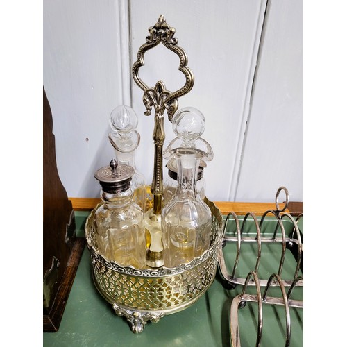 35 - A tantalus with three tags: Brandy, Gin, and Rum 33cm x 34cm, and a collection of silver plate inclu... 