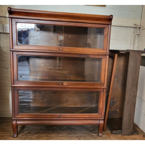 40 - A Globe Wernicke glass fronted four tier bookcase, one tier missing glass and back, slide mechanism ... 