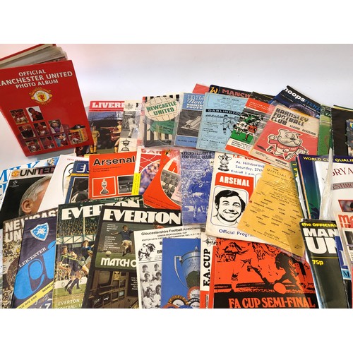 138 - A collection of rare football programmes dating from the 1960's  and an album of official photograph... 