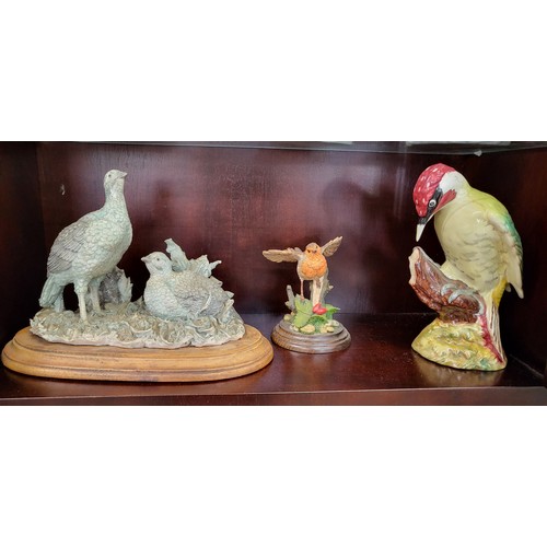 226 - Beswick Green Woodpecker 21cm, Royal Doulton Robin 12cm, and a bisque bird model on oval wood stand.... 