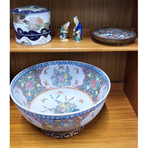 242 - A famille-rose punch bowl 41cm diameter, Japanese three-tiered bowl with lid, two blue and green Sag... 