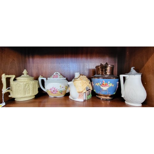 251 - An off-white W.B. Cobridge jug with pewter lid 15cm, a copper lustre jug 17.5cm, and three teapots. ... 