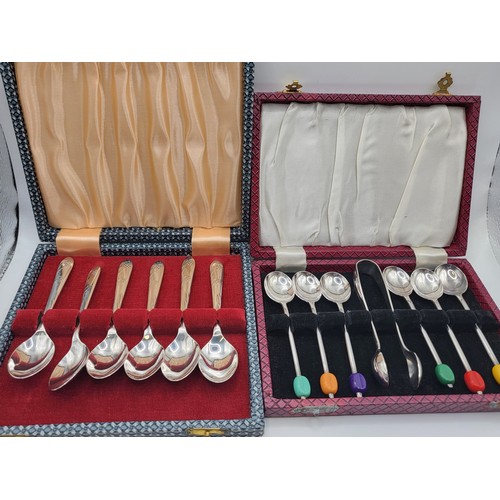 276 - A boxed set of six EPNS coffee spoons with different coloured coffee bean finials and sugar tongs, a... 