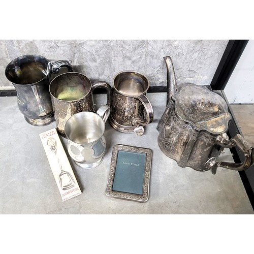 282 - A silver plate teapot, three tankards, one half pint pewter tankard, a sugar spoon, and a silver pla... 