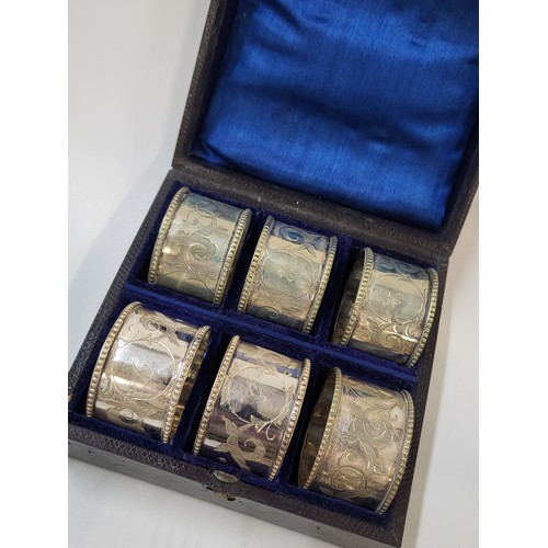 287 - A boxed set of six silver numbered napkin rings (foreign marks) 260gms all in, a silver salver a rai... 