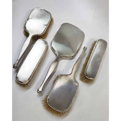 291 - A Mappin & Webb dressing table set comprising of two hair brushes (one brush has a dent) 1939 and 19... 