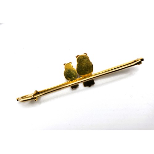 315 - A 9ct yellow gold bar brooch with two owls, perched, with ruby eyes. Boxed  3.5gms. 5.5cm.