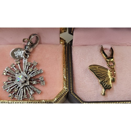 337 - Six Juicy Couture charm/pendants in original branded boxes including Pegasus, dog, snowflake, Tinker... 