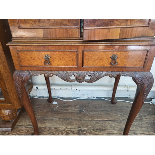 27 - A two-door cocktail mirror-back cabinet (with broken glass shelf),  over two short drawers supported... 