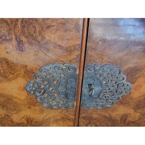 27 - A two-door cocktail mirror-back cabinet (with broken glass shelf),  over two short drawers supported... 