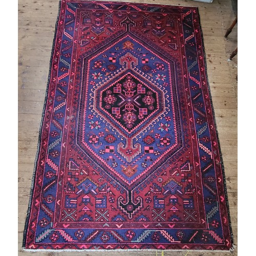 56 - An Iranian red ground rug by Grutman 140 x 225cm.
