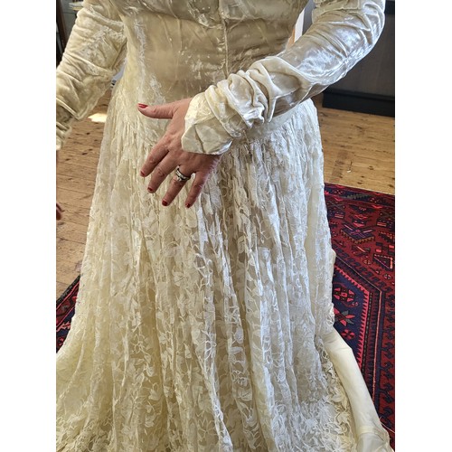 97 - A 1950's wedding dress with a crushed velvet bodice, long tapered sleeves with a V finish, ivy leaf ... 