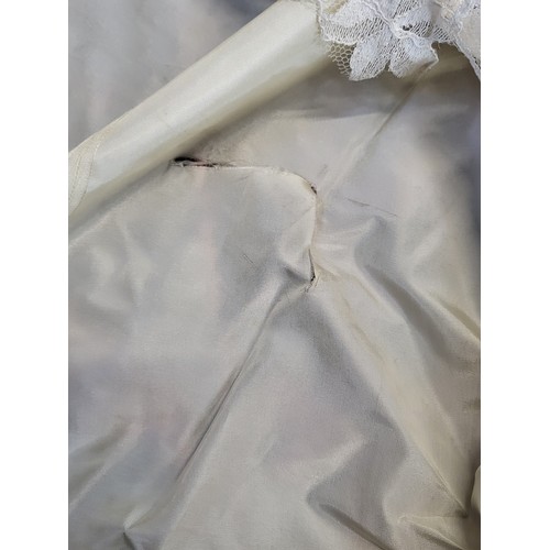 97 - A 1950's wedding dress with a crushed velvet bodice, long tapered sleeves with a V finish, ivy leaf ... 