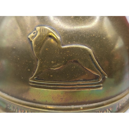 101 - A round brass tea caddy produced as a souvenir of the British Empire Exhibition by Lipton's tea comp... 