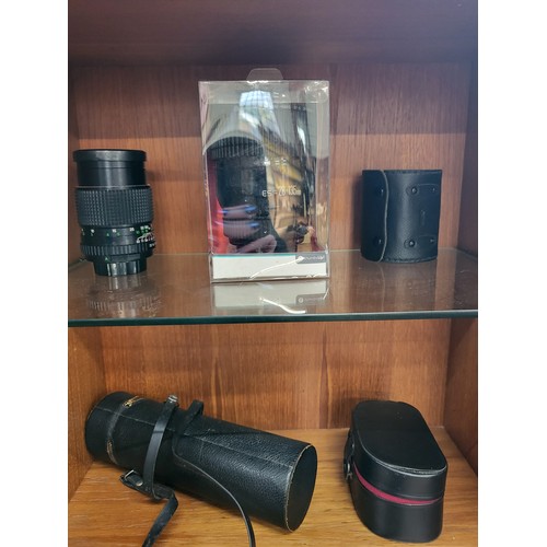 102 - A collection of four various camera lenses, a Prinzgology No 49164 with camera case, Bell & Howell s... 