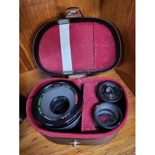 102 - A collection of four various camera lenses, a Prinzgology No 49164 with camera case, Bell & Howell s... 