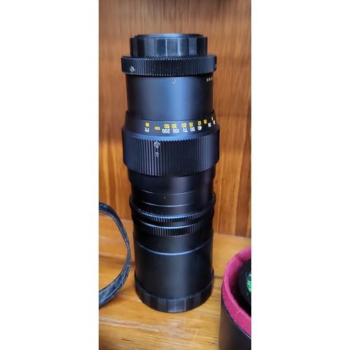 102 - A collection of four various camera lenses, a Prinzgology No 49164 with camera case, Bell & Howell s... 