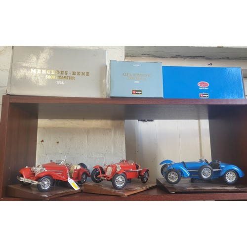 109 - Three Burago 1930's sports cars including Mercedes-Benz, Bugatti, and Alfa-Romeo in boxes. (3)